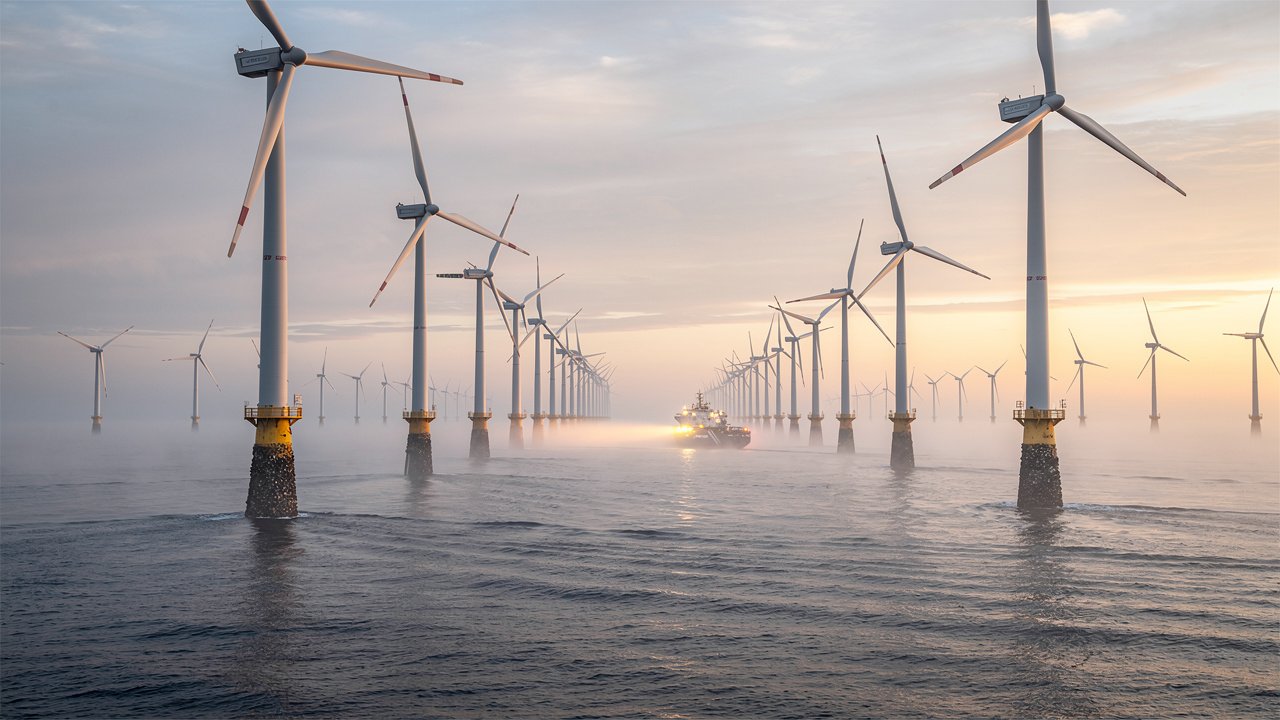 Offshore wind turbines at sunrise over calm North Sea waters